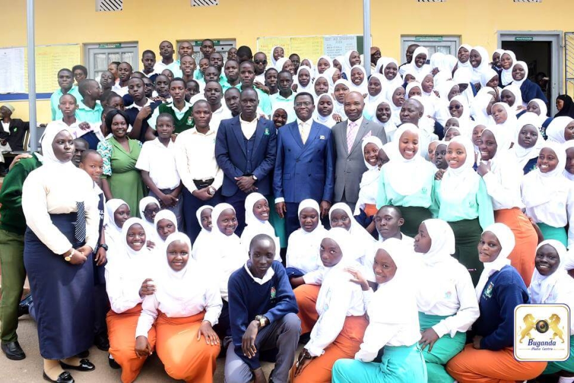 The Katikkiro in a group photo with the students and school administrators The Katikkiro in a group photo with the students and school administrators